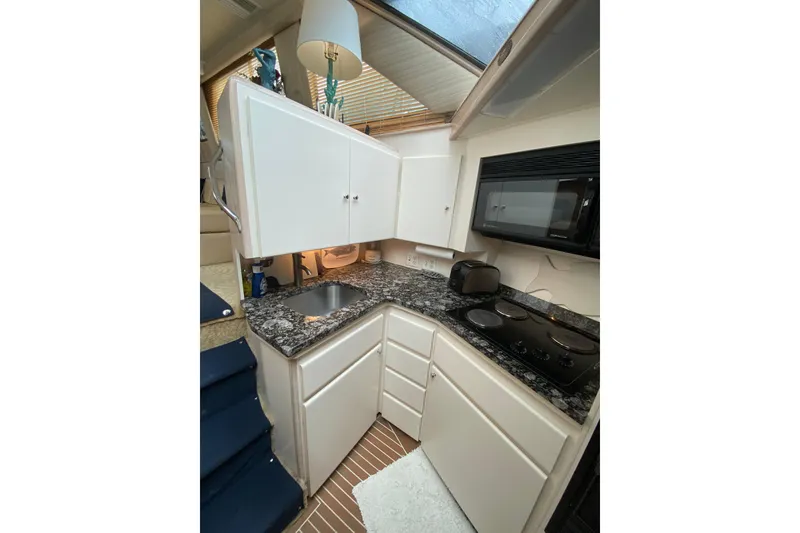 Slide: The Image of Compact kitchen in 1991 Hatteras 40 Motor Yacht with granite countertops and modern appliances. - 40