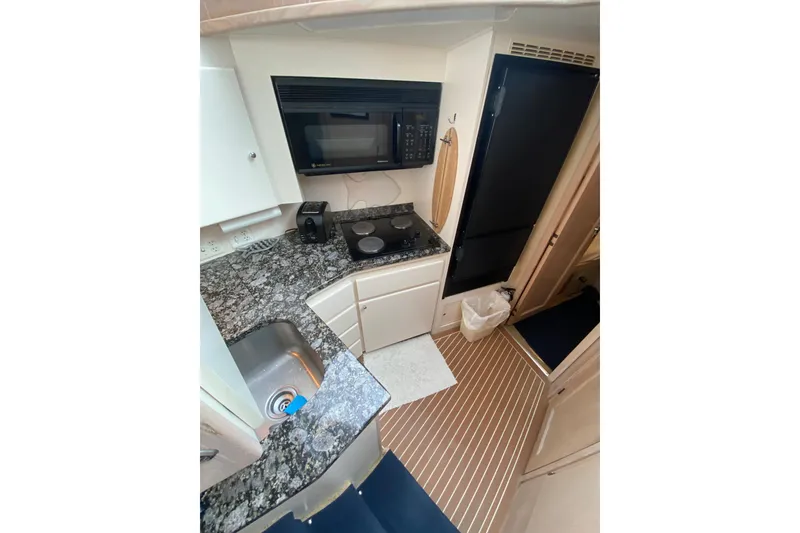 Slide: The Image of 1991 Hatteras 40 Motor Yacht kitchen with granite countertops and modern appliances. - 41