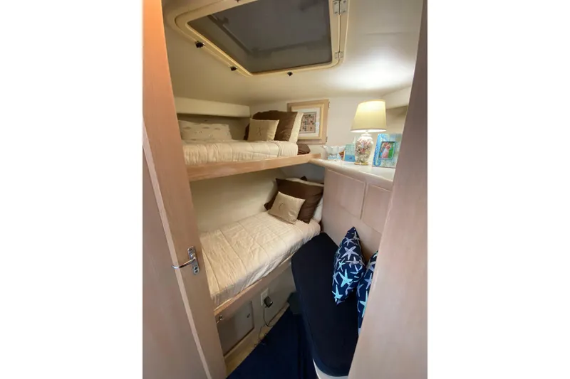 Slide: The Image of Interior of 1991 Hatteras 40 Motor Yacht with cozy bunk beds and decorative pillows. - 42