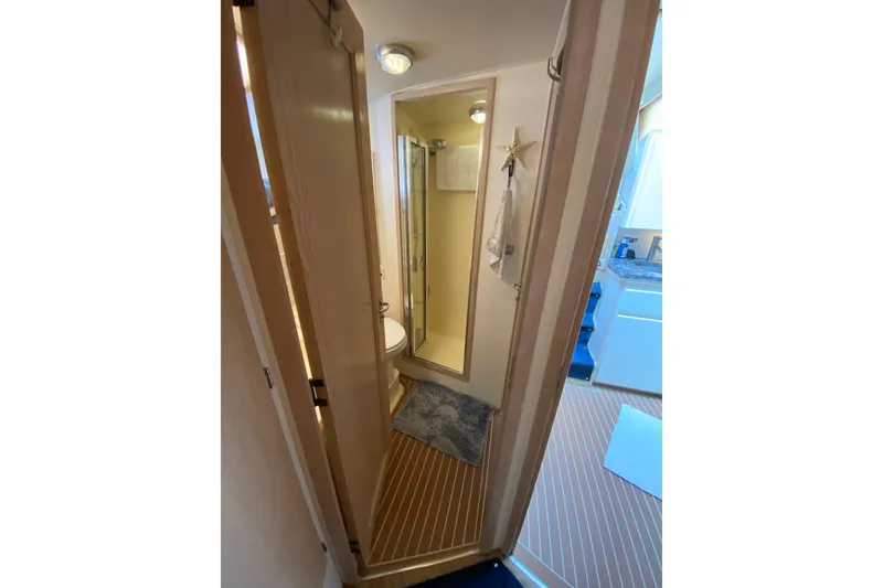 Slide: The Image of Bathroom interior of 1991 Hatteras 40 Motor Yacht with shower and wooden flooring. - 43