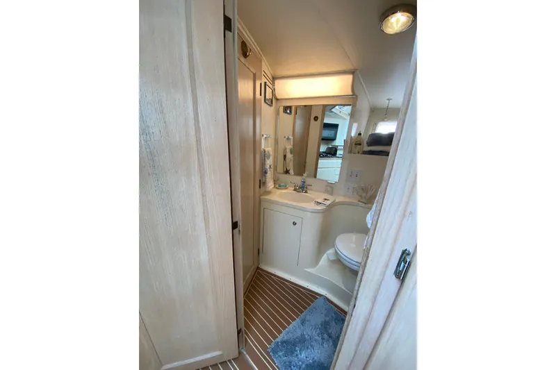 Slide: The Image of Bathroom interior of 1991 Hatteras 40 Motor Yacht with wooden accents and modern fixtures. - 44