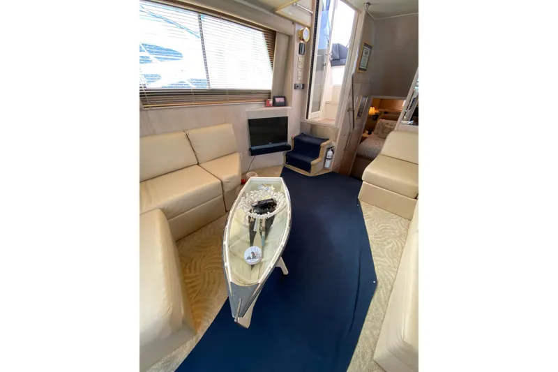 Slide: The Image of Luxurious interior of 1991 Hatteras 40 Motor Yacht with elegant seating and decor. - 46