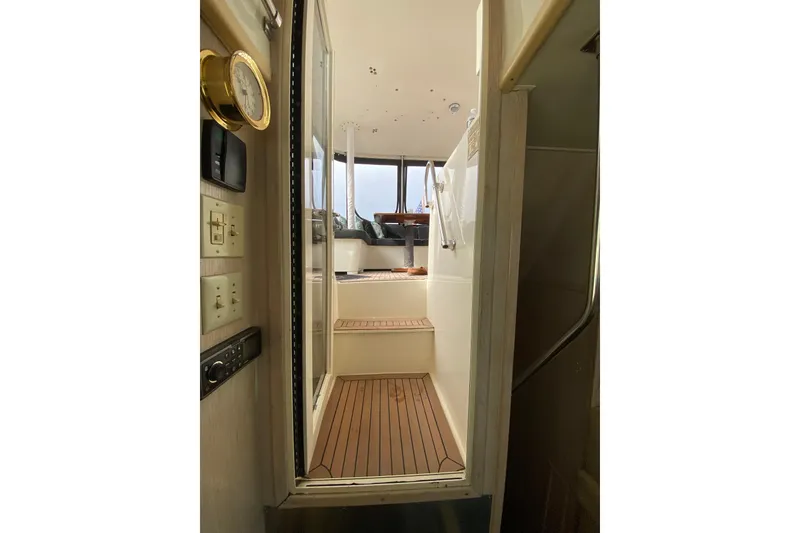 Slide: The Image of Interior view of 1991 Hatteras 40 Motor Yacht with wooden flooring and steps. - 47