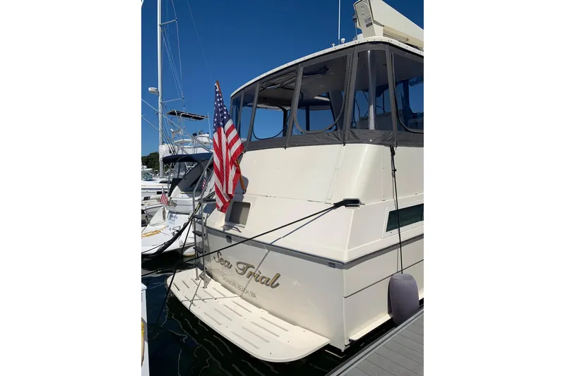 Slide: The Image of 1991 Hatteras 40 Motor Yacht docked with American flag displayed. - 56