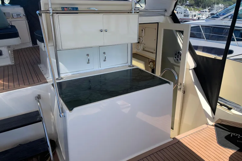 Slide: The Image of 1991 Hatteras 40 Motor Yacht interior with cabinetry and seating on deck. - 58