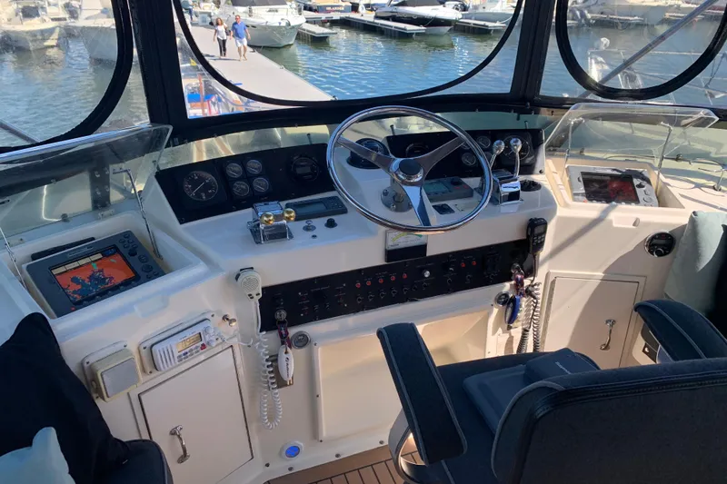 Slide: The Image of Cockpit of 1991 Hatteras 40 Motor Yacht with steering wheel and navigation equipment. - 72