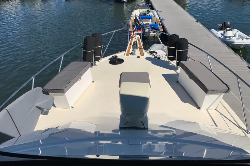 Slide: The Image of 1991 Hatteras 40 Motor Yacht docked, featuring spacious deck and seating area. - 77