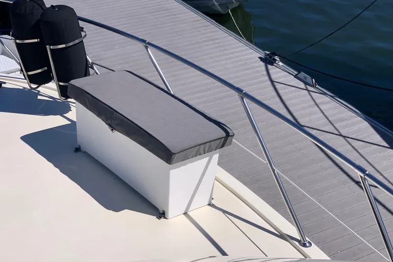 Slide: The Image of 1991 Hatteras 40 Motor Yacht deck with cushioned seating and railing. - 79