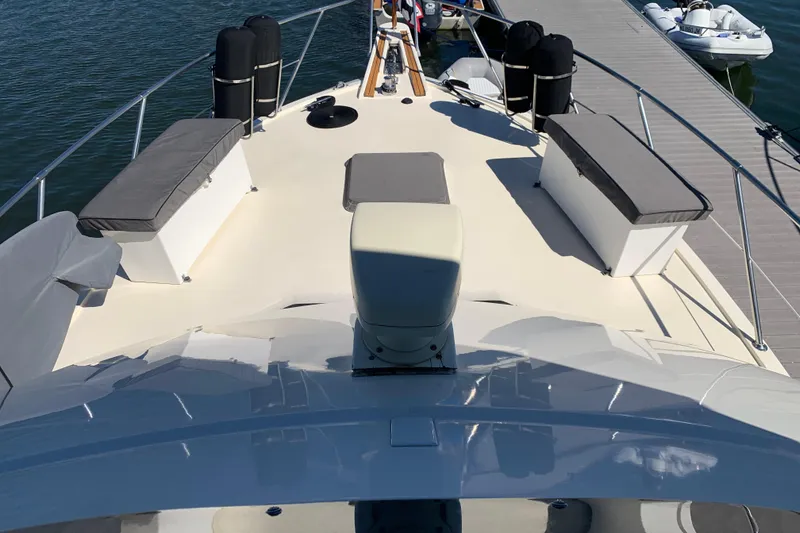 Slide: The Image of 1991 Hatteras 40 Motor Yacht deck with cushioned seating and dock view. - 80