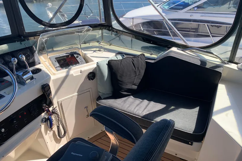 Slide: The Image of 1991 Hatteras 40 Motor Yacht helm with seating, controls, and navigation equipment. - 81