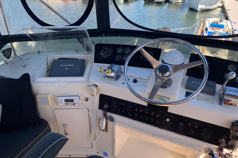 Slide: The Image of 1991 Hatteras 40 Motor Yacht helm with steering wheel and navigation equipment. - 83