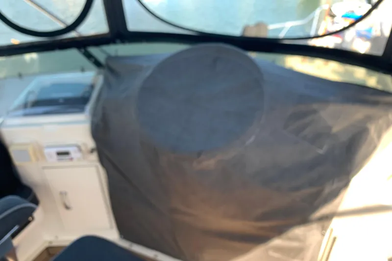 Slide: The Image of 1991 Hatteras 40 Motor Yacht cockpit with covered controls and seating area. - 85