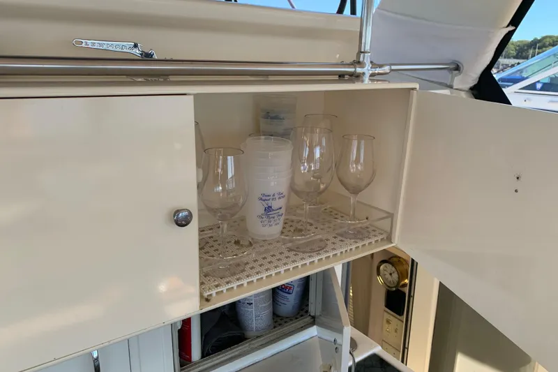 Slide: The Image of Cabinet with glasses and cups on 1991 Hatteras 40 Motor Yacht. - 88