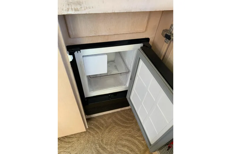 Slide: The Image of Open refrigerator in 1991 Hatteras 40 Motor Yacht interior. - 92