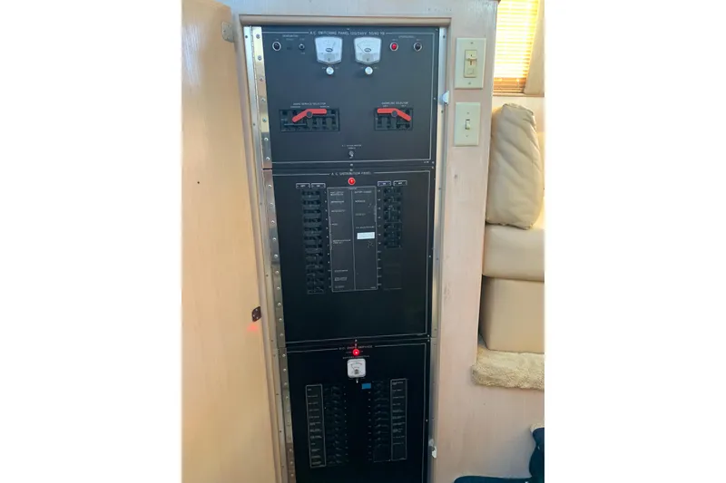 Slide: The Image of Electrical panel inside 1991 Hatteras 40 Motor Yacht, featuring switches and circuit breakers. - 94
