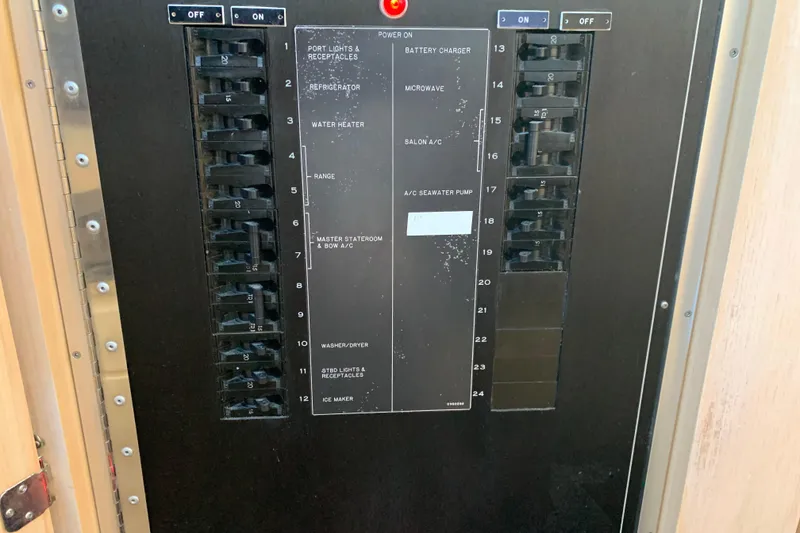 Slide: The Image of Electrical panel of a 1991 Hatteras 40 Motor Yacht with labeled switches and controls. - 96