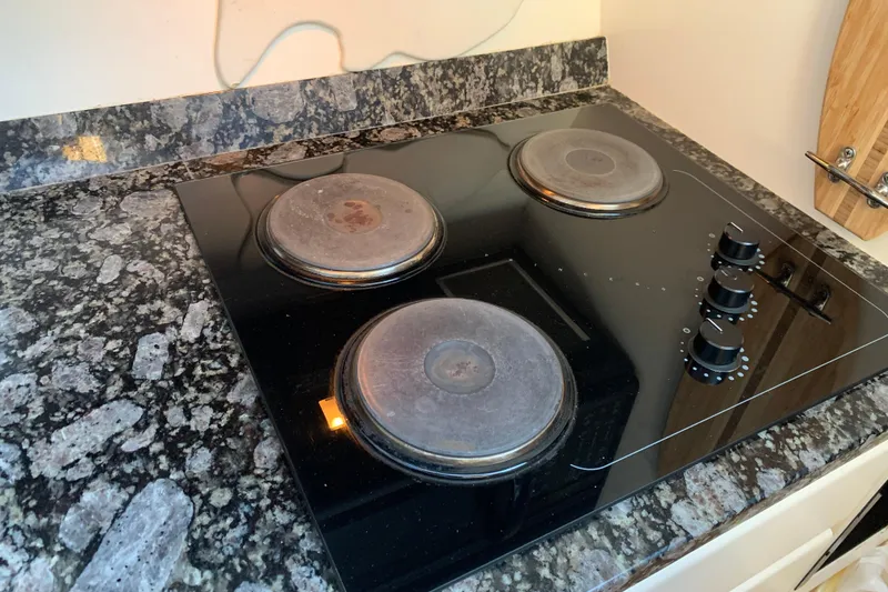 Slide: The Image of Electric stovetop on granite countertop in 1991 Hatteras 40 Motor Yacht kitchen. - 99