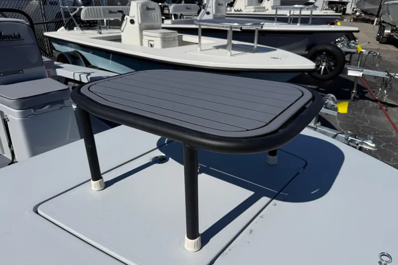 Slide: The Image of 2026 Maverick 17 HPX-S boat deck with elevated platform, parked in a marina. - 12