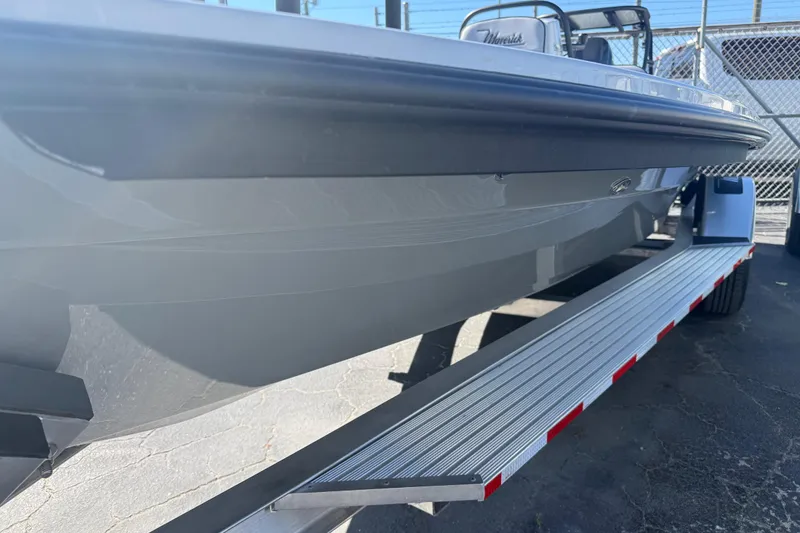 Slide: The Image of 2026 Maverick 17 HPX-S boat on trailer, side view, in a parking lot. - 2