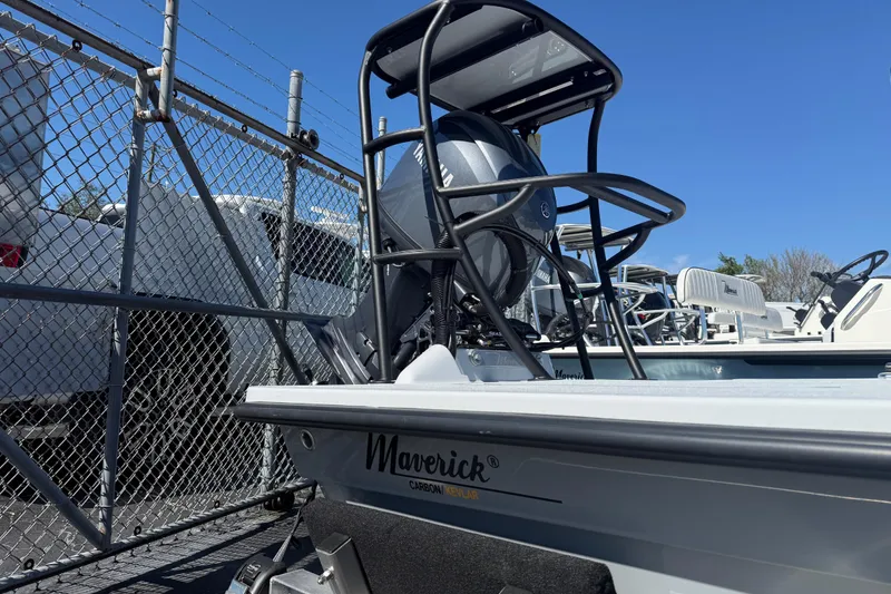 Slide: The Image of 2026 Maverick 17 HPX-S boat parked near a chain-link fence under clear blue sky. - 8