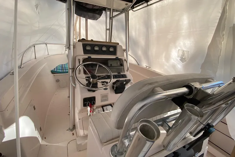 Slide: The Image of 1999 Grady-White Chase 263 boat interior with steering wheel and control panel. - 12