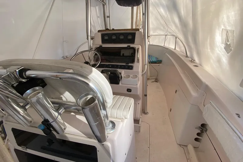 Slide: The Image of 1999 Grady-White Chase 263 boat interior with steering console and seating. - 14