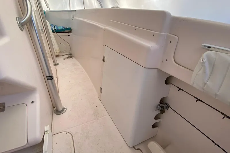 Slide: The Image of 1999 Grady-White Chase 263 boat interior with storage compartments and seating area. - 16