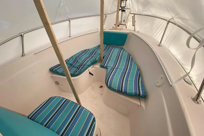 Slide: The Image of 1999 Grady-White Chase 263 boat interior with striped cushions and white canopy. - 20