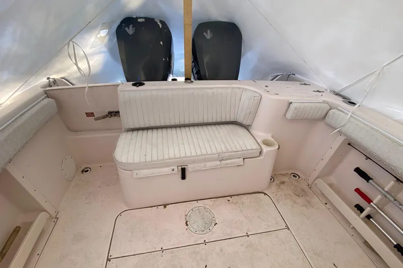 Slide: The Image of 1999 Grady-White Chase 263 boat interior with seating and storage compartments. - 24