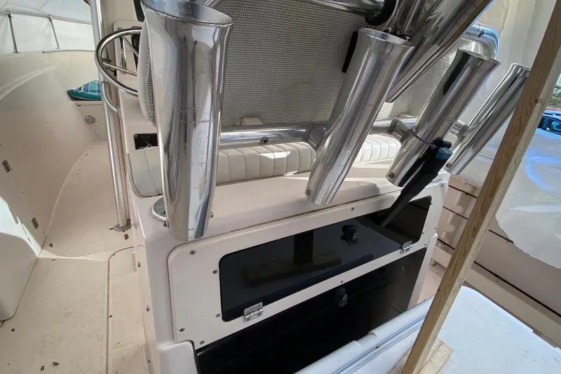 Slide: The Image of 1999 Grady-White Chase 263 boat interior with rod holders and seating. - 29