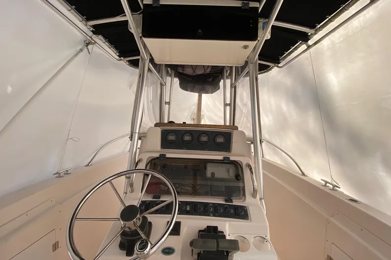 Slide: The Image of 1999 Grady-White Chase 263 boat interior with steering wheel and control panel. - 3