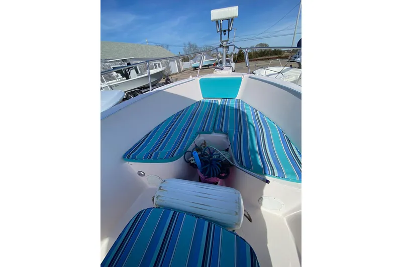 Slide: The Image of 1999 Grady-White Chase 263 boat with striped seating and nautical equipment. - 34