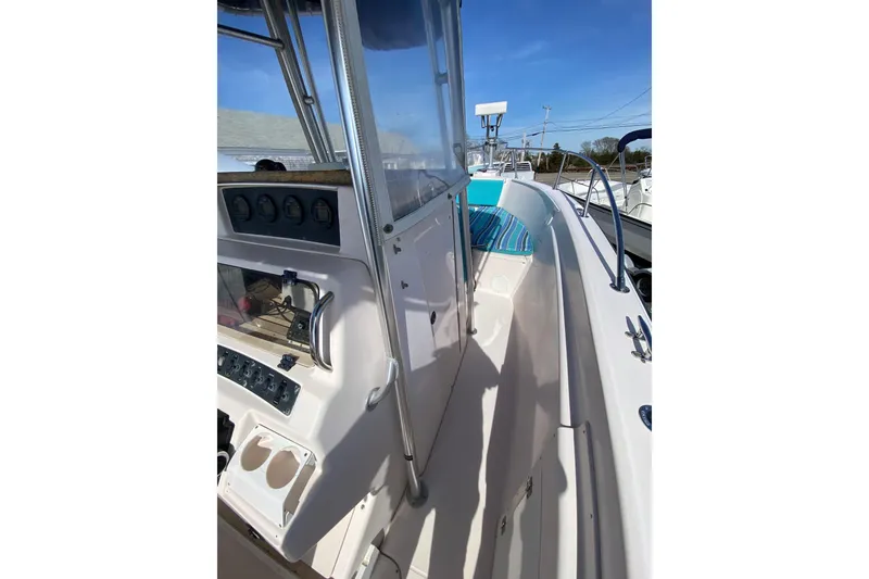 Slide: The Image of 1999 Grady-White Chase 263 boat interior with control panel and seating area. - 36