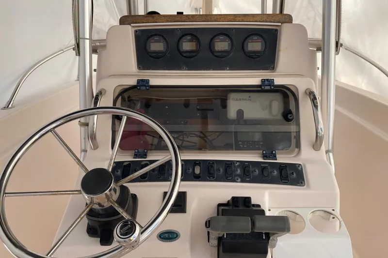 Slide: The Image of 1999 Grady-White Chase 263 boat dashboard with steering wheel and control panel. - 4
