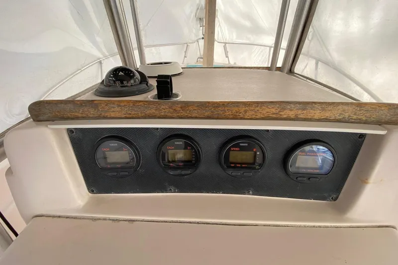 Slide: The Image of Dashboard of 1999 Grady-White Chase 263 boat with gauges and compass. - 5