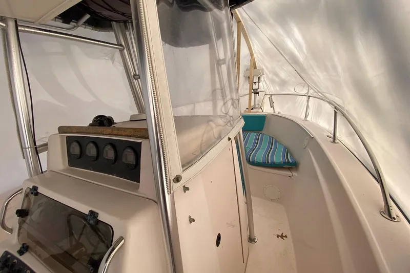 Slide: The Image of 1999 Grady-White Chase 263 boat interior with control panel and seating area. - 9