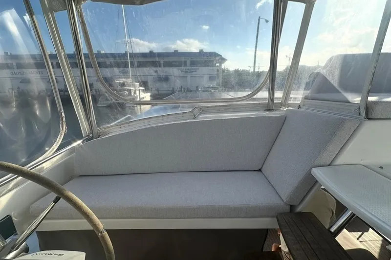 Slide: The Image of 2014 Fountaine Pajot Helia 44 yacht cockpit with cushioned seating and clear windows. - 10