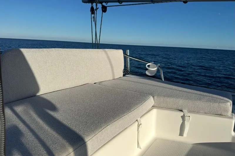 Slide: The Image of Fountaine Pajot Helia 44 catamaran deck with cushioned seating, ocean view, 2014 model. - 11