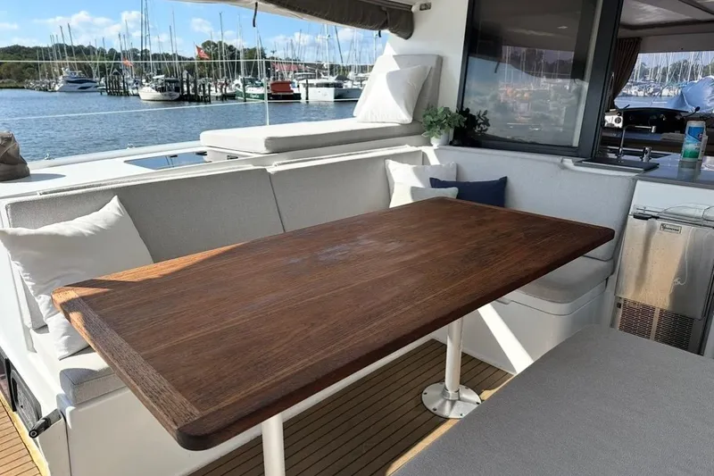 Slide: The Image of Luxurious 2014 Fountaine Pajot Helia 44 yacht with elegant outdoor seating and wooden table. - 12