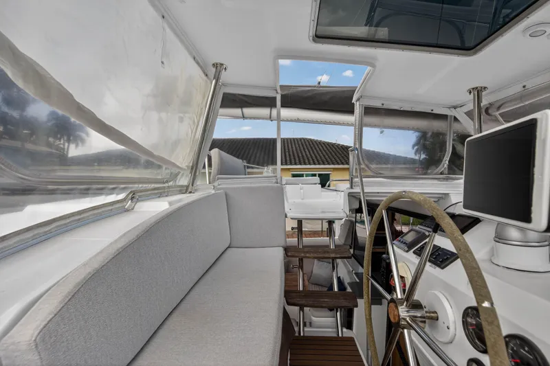 Slide: The Image of Interior view of 2014 Fountaine Pajot Helia 44 catamaran cockpit with steering wheel and seating. - 18