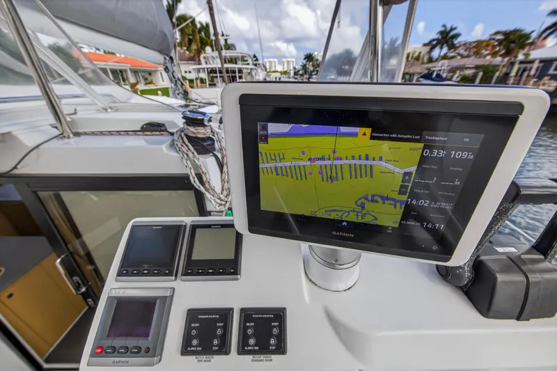 Slide: The Image of Helia 44 catamaran cockpit with Garmin navigation display, showcasing marina view. - 21
