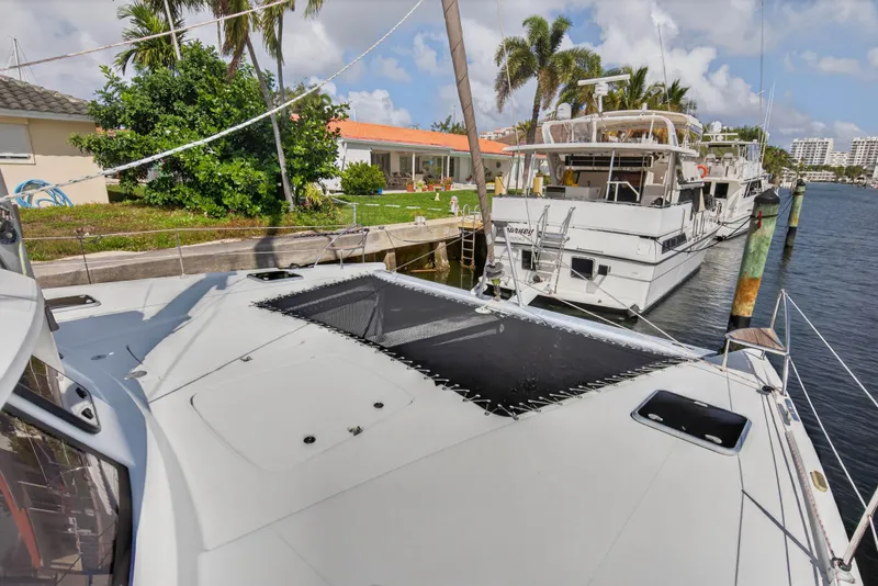 Slide: The Image of 2014 Fountaine Pajot Helia 44 catamaran docked near waterfront homes. - 32