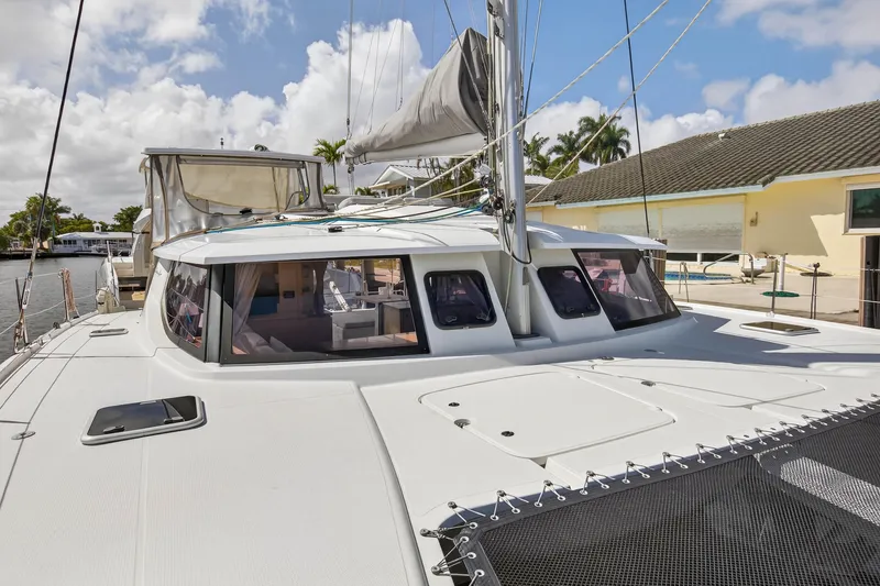 Slide: The Image of 2014 Fountaine Pajot Helia 44 catamaran docked, showcasing sleek design and spacious deck. - 34