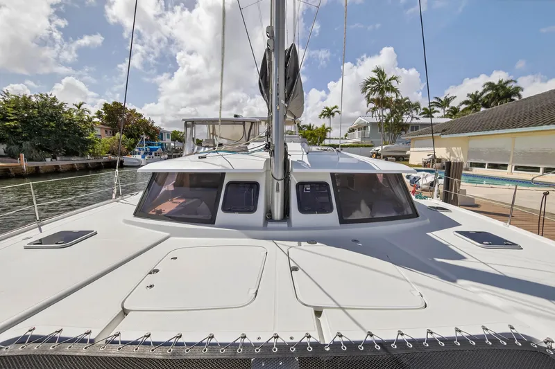 Slide: The Image of 2014 Fountaine Pajot Helia 44 catamaran docked, showcasing sleek design and spacious deck. - 35
