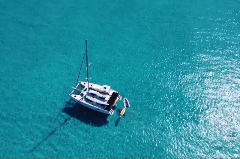 Slide: The Image of Aerial view of 2014 Fountaine Pajot Helia 44 catamaran on clear turquoise water. - 4