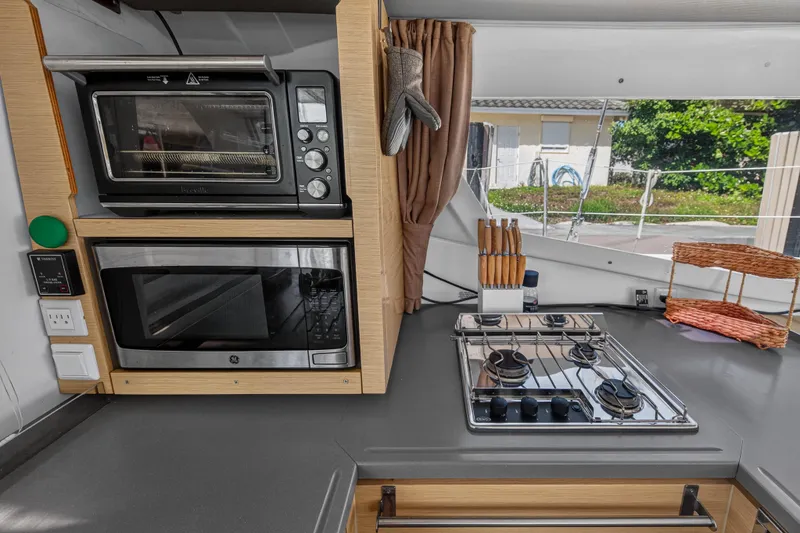 Slide: The Image of Modern kitchen in 2014 Fountaine Pajot Helia 44 catamaran with stove, oven, and microwave. - 46