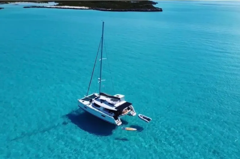 Slide: The Image of 2014 Fountaine Pajot Helia 44 catamaran sailing in clear turquoise waters. - 5