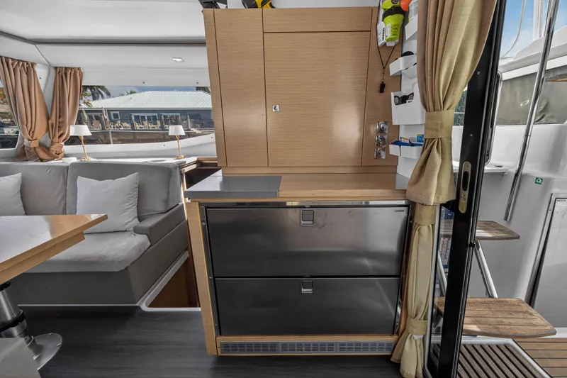 Slide: The Image of Interior of 2014 Fountaine Pajot Helia 44 catamaran with modern kitchen and cozy seating area. - 52