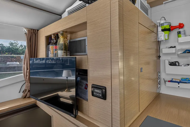 Slide: The Image of Modern interior of 2014 Fountaine Pajot Helia 44 yacht with wooden cabinetry and mounted TV. - 55