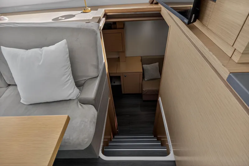 Slide: The Image of Interior of 2014 Fountaine Pajot Helia 44 yacht, featuring stairs and cozy seating area. - 56